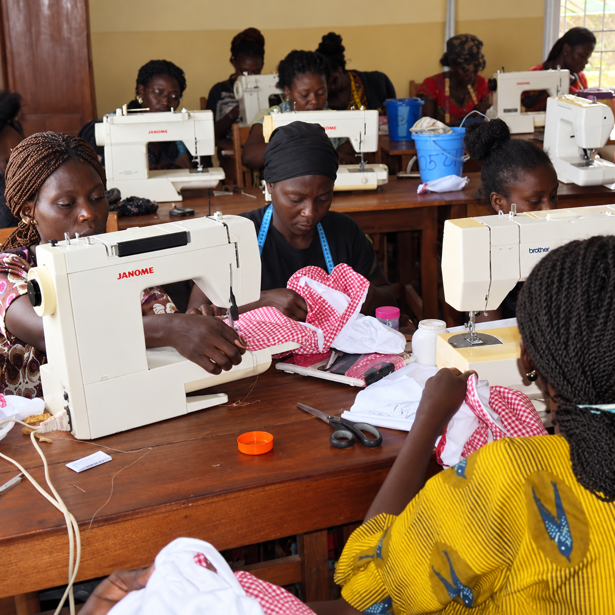 Young mother learning sewing